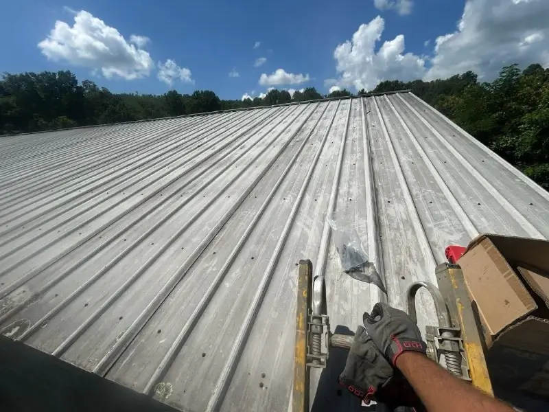 Metal Roof Repair Conroe TX 4 Roofer performing a metal roof inspection and leak diagnosis in Conroe TX