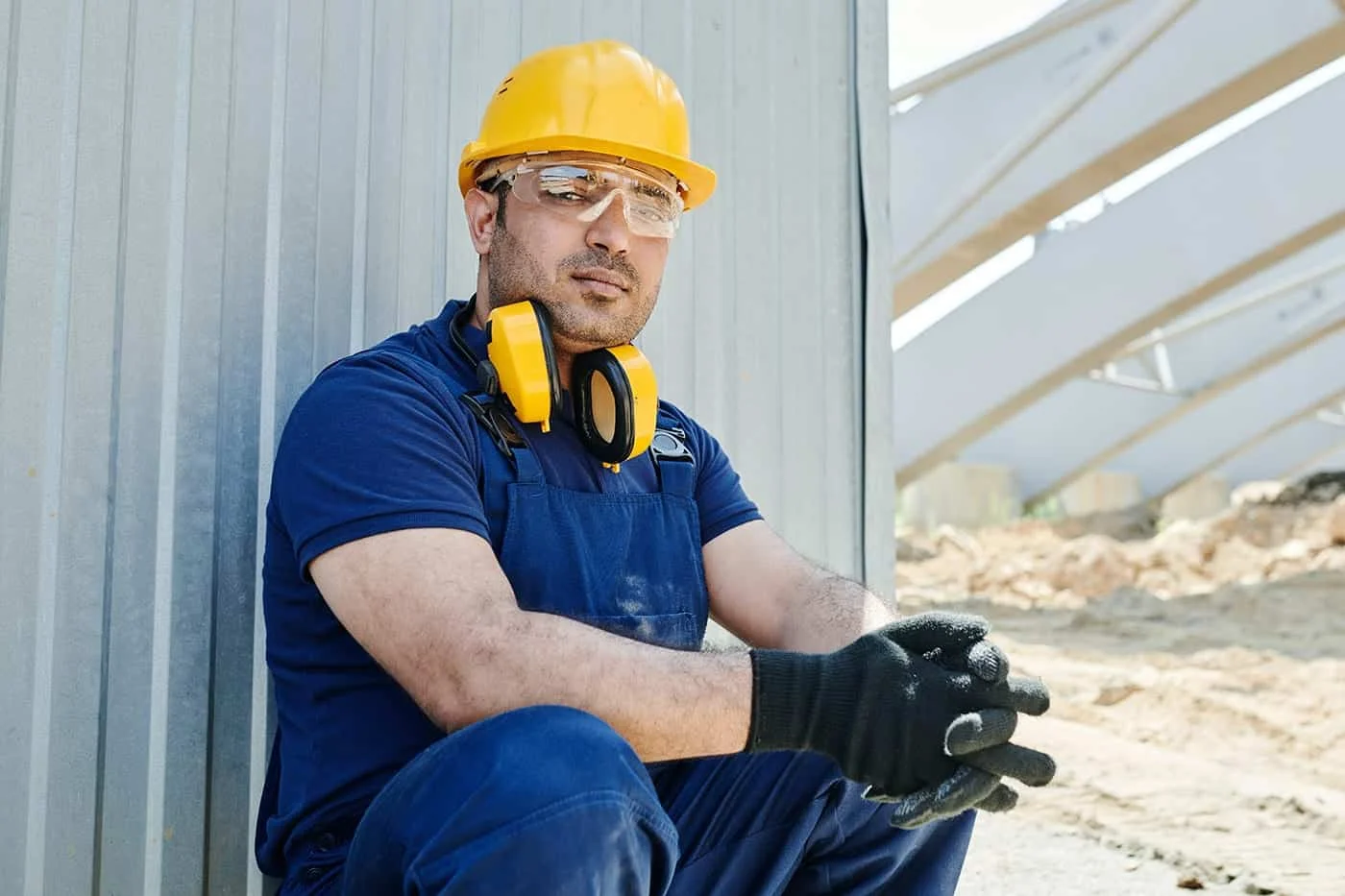 Metal Roof Repair Conroe TX 8 Metal roofing expert examining panel seams and fasteners on a Conroe TX roof